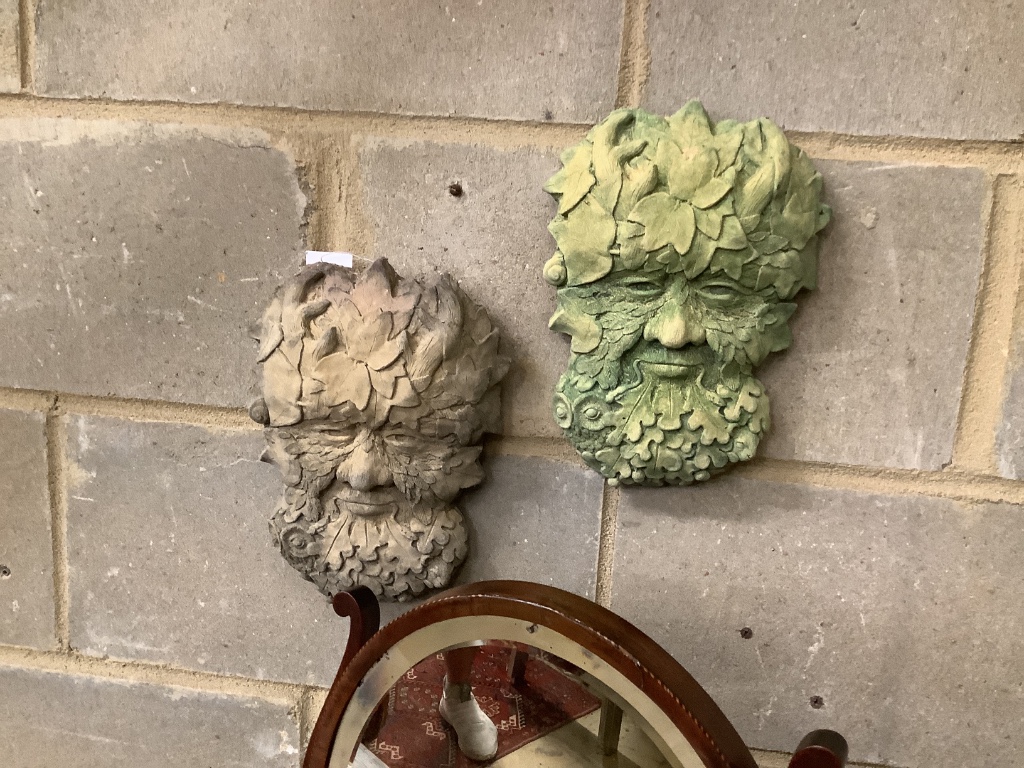 A pair of reconstituted stone wall appliques of 'The Green Man', width 18cm, height 28cm